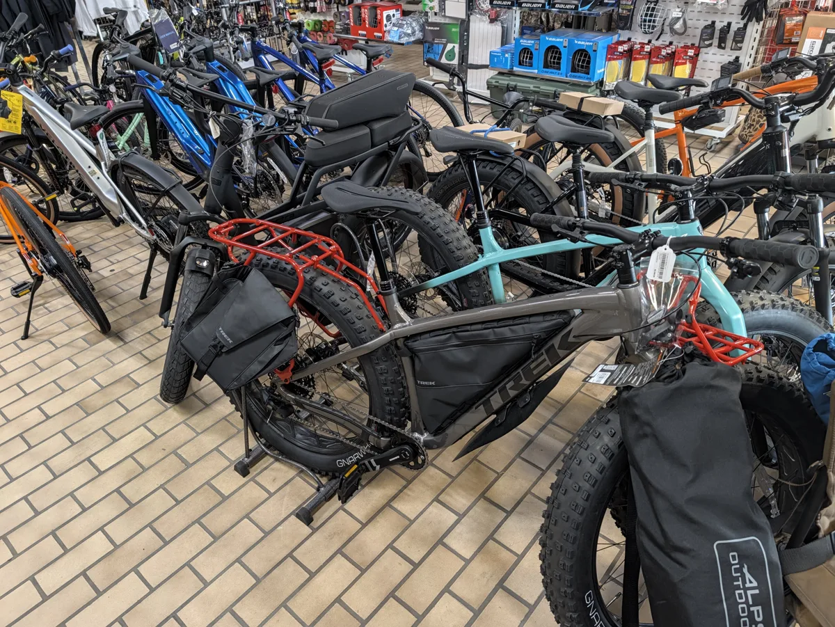 Trek and other e-bikes on the sales floor at All Seasons Sports in Delano